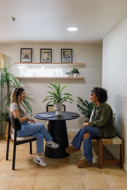 Two residents sit in a kitchen at The Colleges at La Rue.
